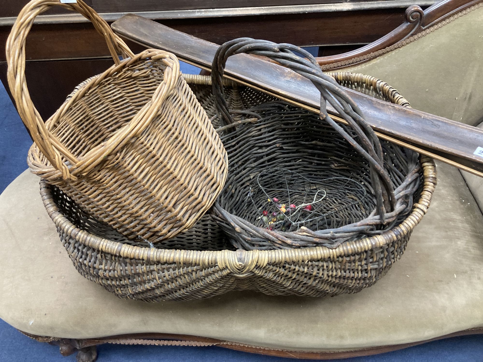 Three wicker baskets, a wirework basket and two baguette stands